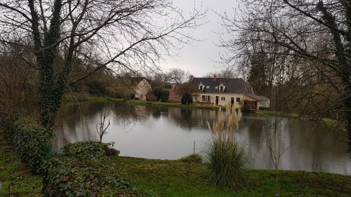 French house by a pond