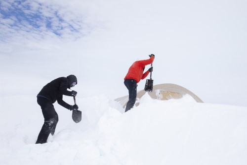 Digging out tents during a break in the weather